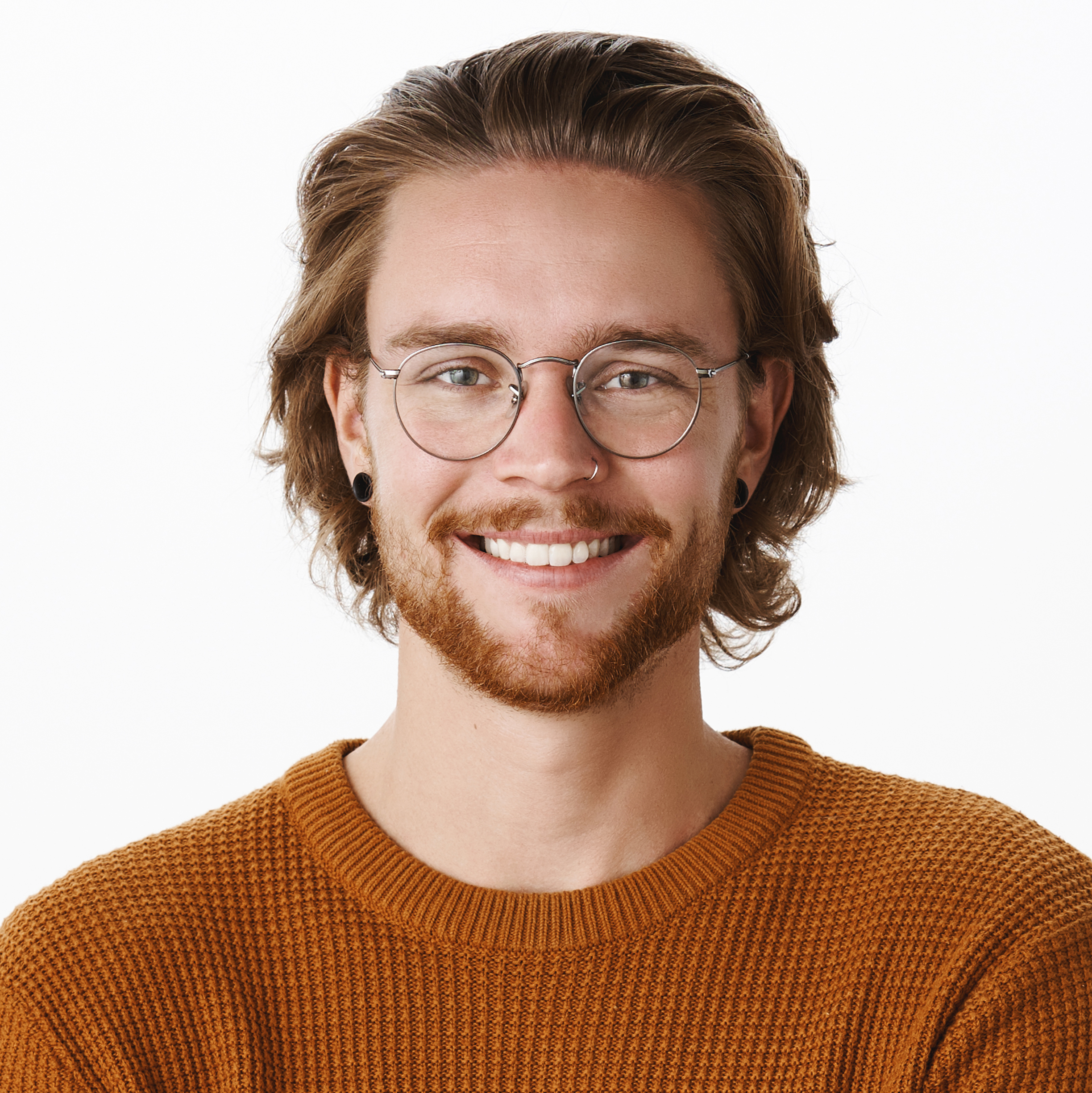 Waist-up shot of satisfied successful male programmer in glasses with beard holding hands crossed over chest in confident self-satisfied pose smiling pleased at camera against gray background.